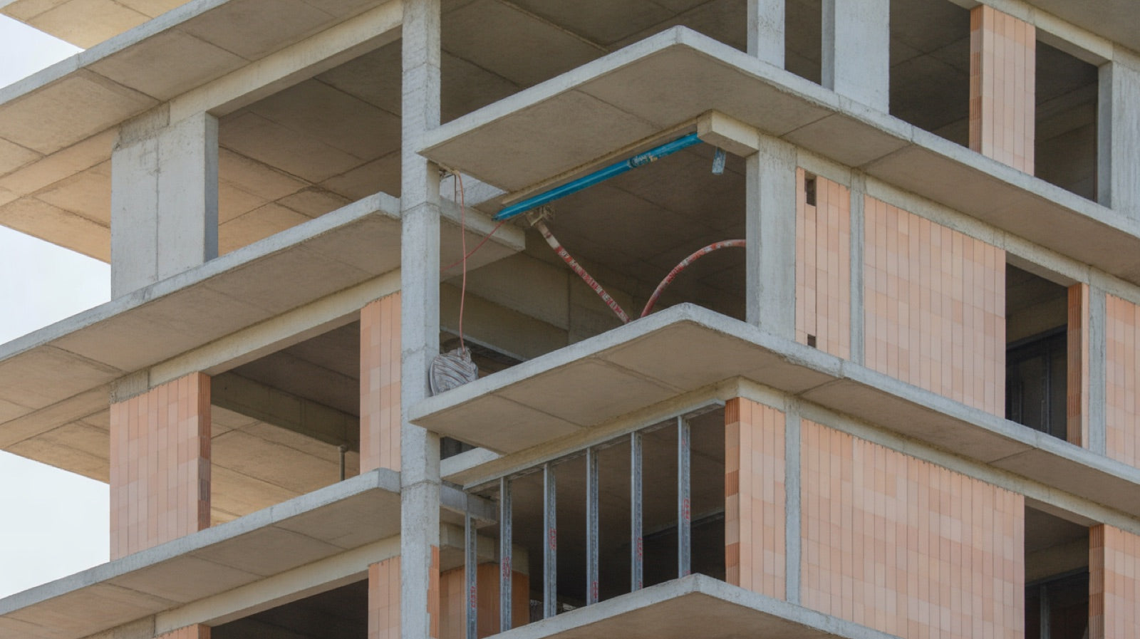 BIM vs CAD: a building under construction with an exposed steel and concrete structure and service pipes being installed